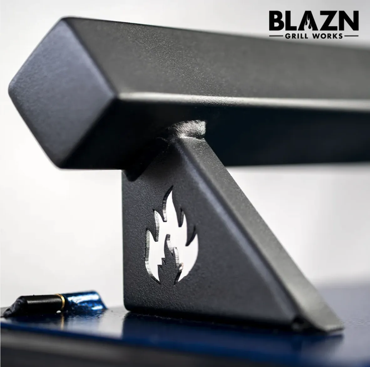 Blazn Grill Works Grid Iron Pellet Grill, close-up of the lid handle with flame cut-out