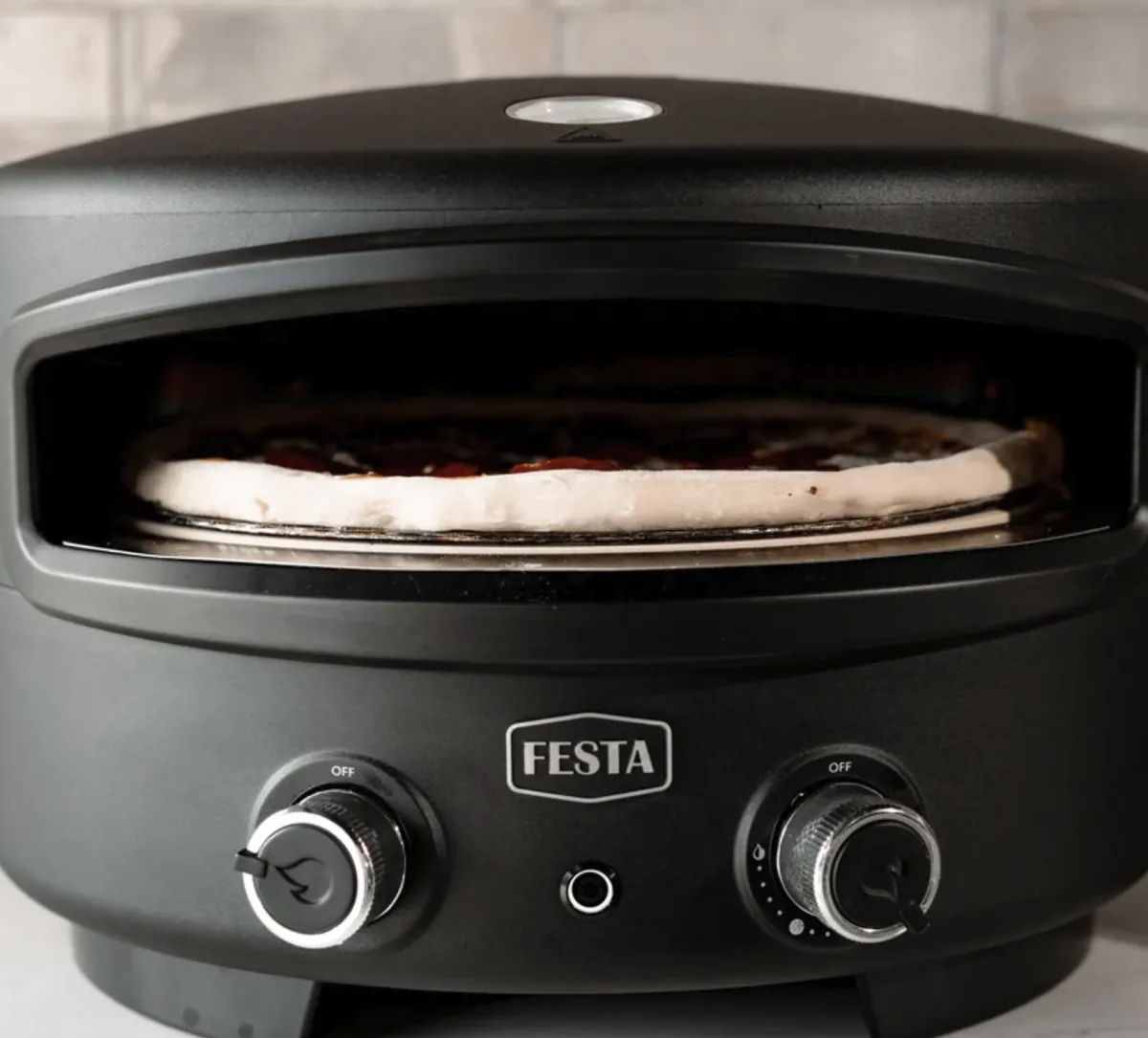 Festa Pizza Co Dual-Heat Rotating Pizza Oven, front view with a pizza baking inside