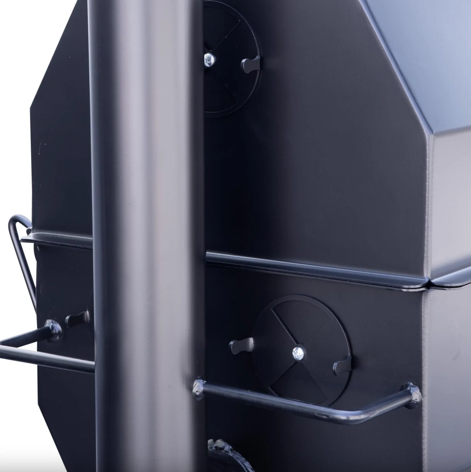 Close-up of Meadow Creek SQ36 smoker chimney and circular adjustable air dampers on the cooking chamber.