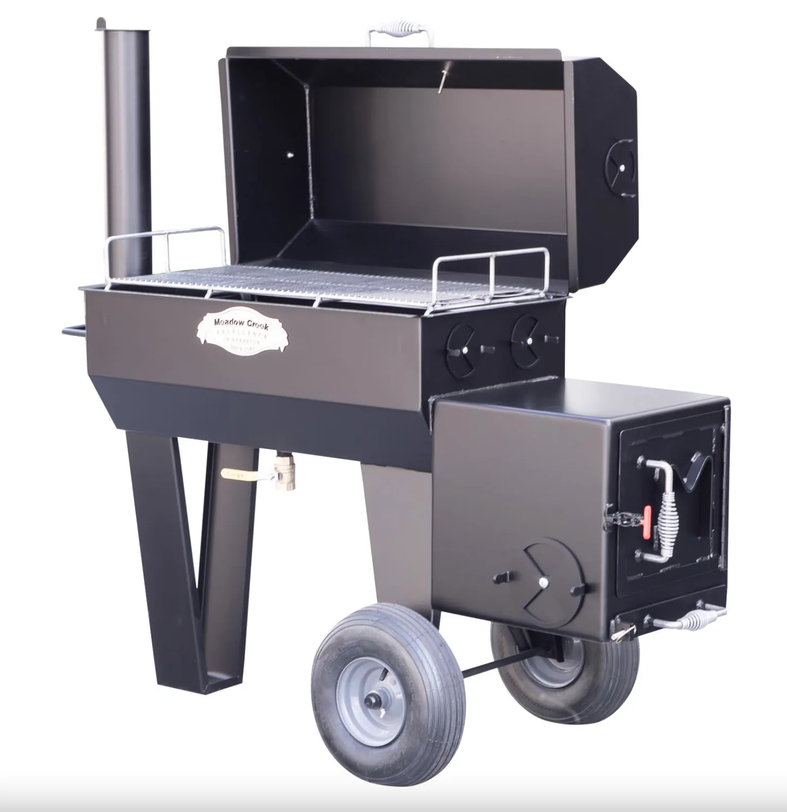 Meadow Creek SQ36 smoker with lid open, showing two levels of metal cooking grates and side chimney.