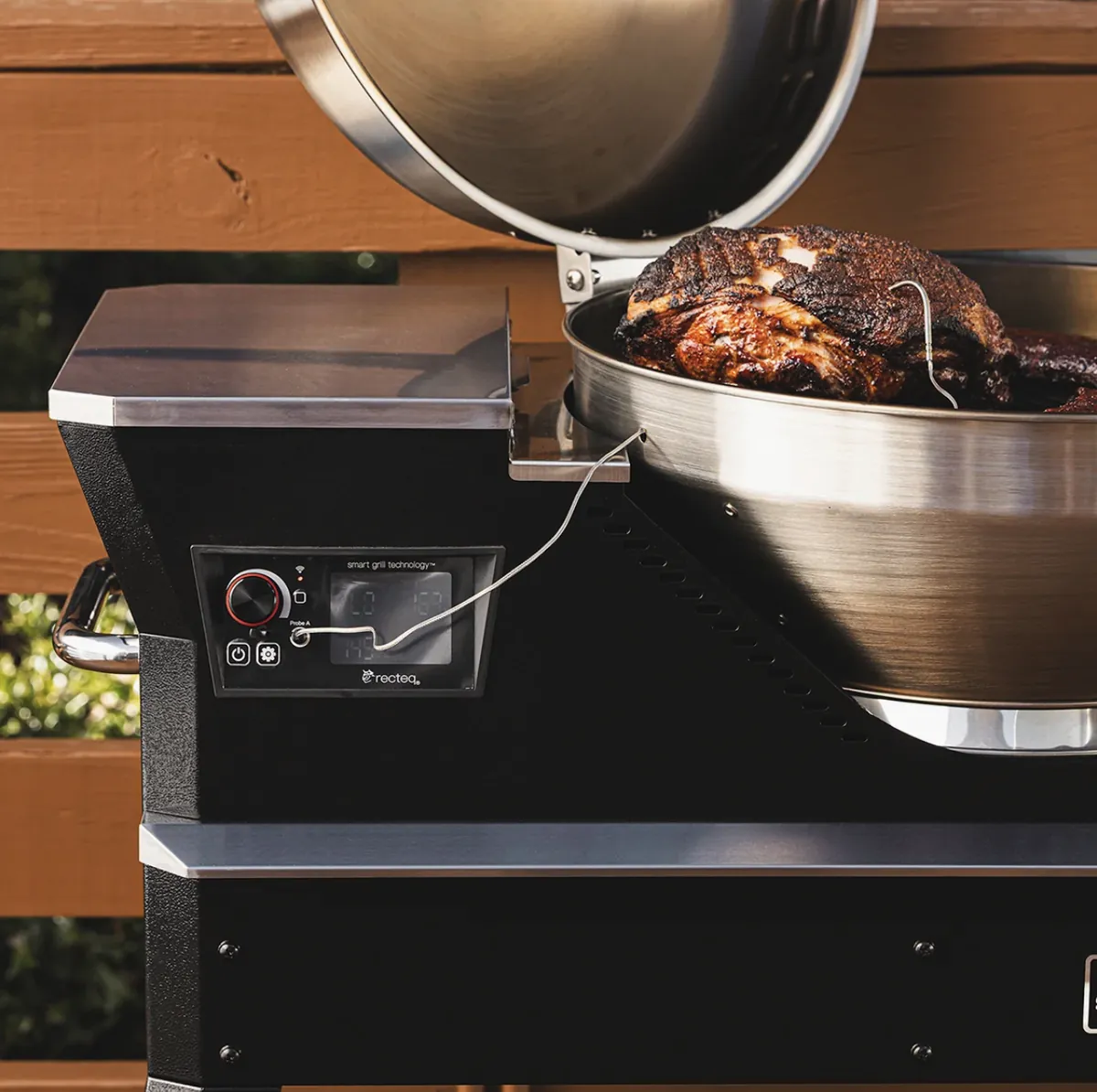 Recteq Bullseye Deluxe 380BD Pellet Grill, smoking pork with a meat probe connected to the smart controller