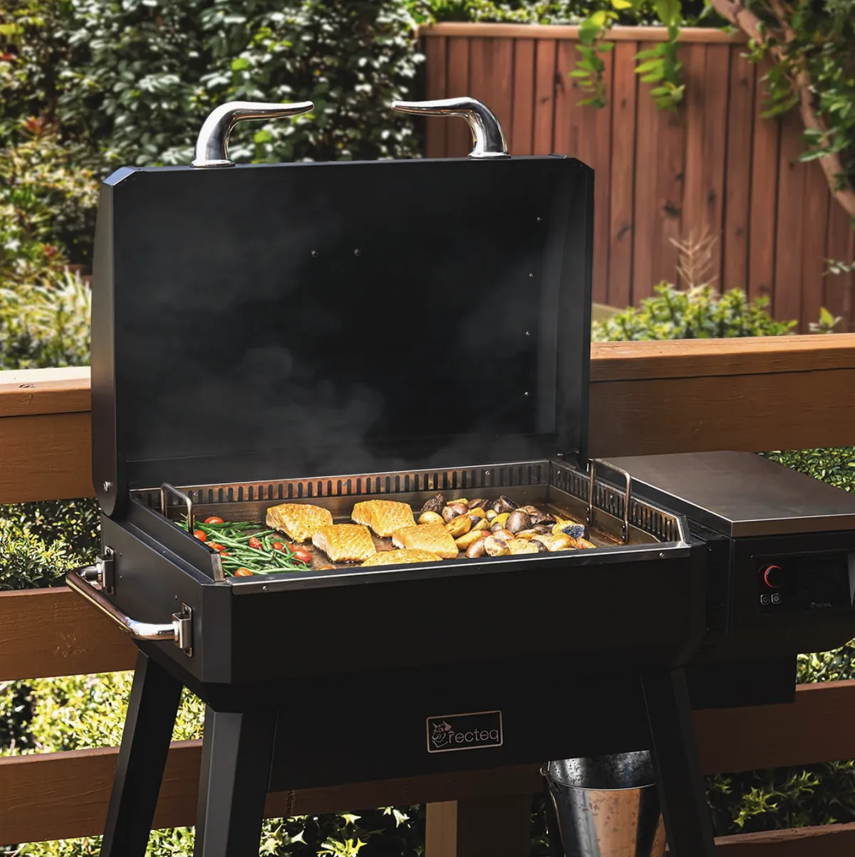 Recteq SmokeStone 480 Pellet Griddle, cooking salmon, green beans and potatoes on a deck
