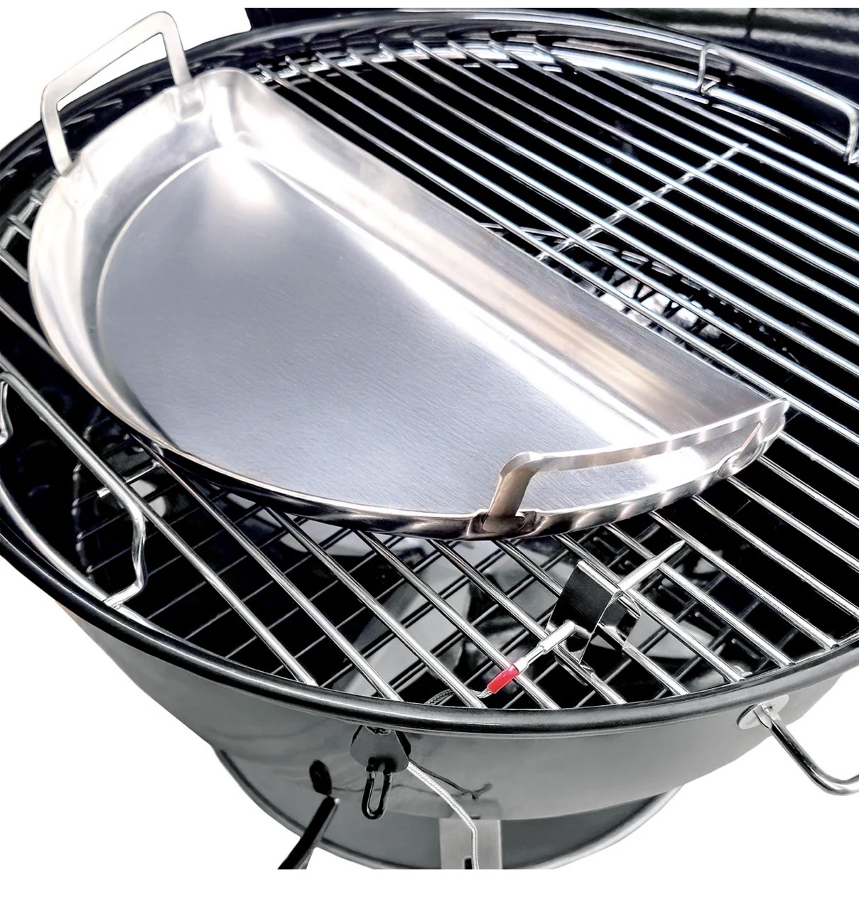 Stainless steel drip pan resting on cooking grate inside SnS 18-inch charcoal kettle grill