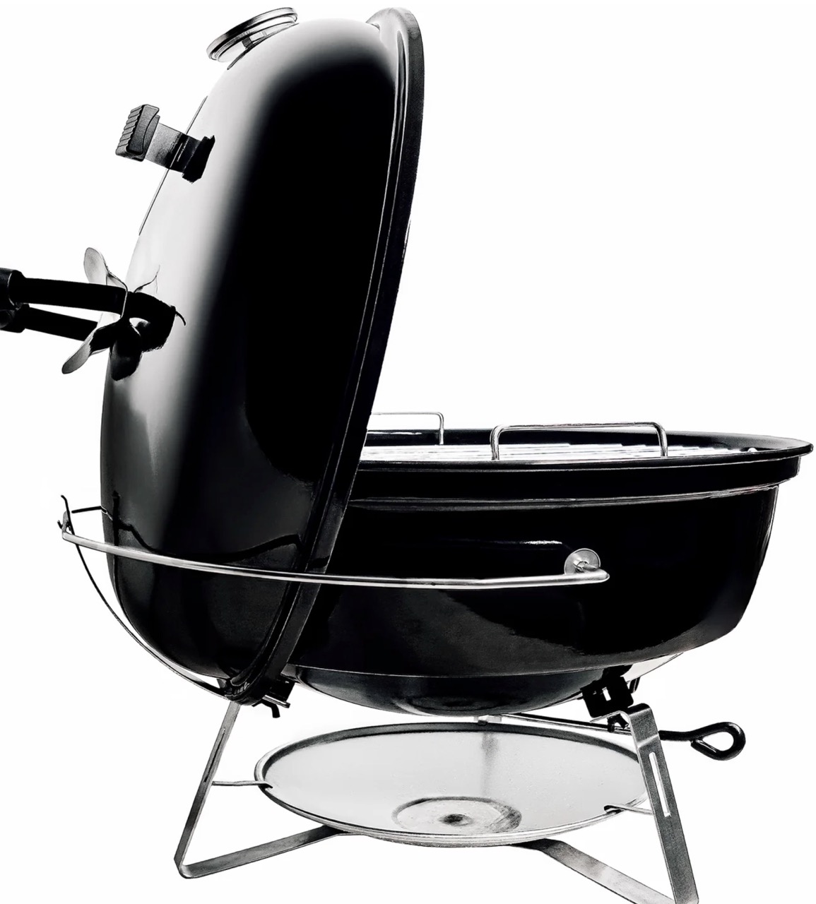 Side view of SnS 18-inch Travel Kettle charcoal grill with lid held upright by integrated lid holder