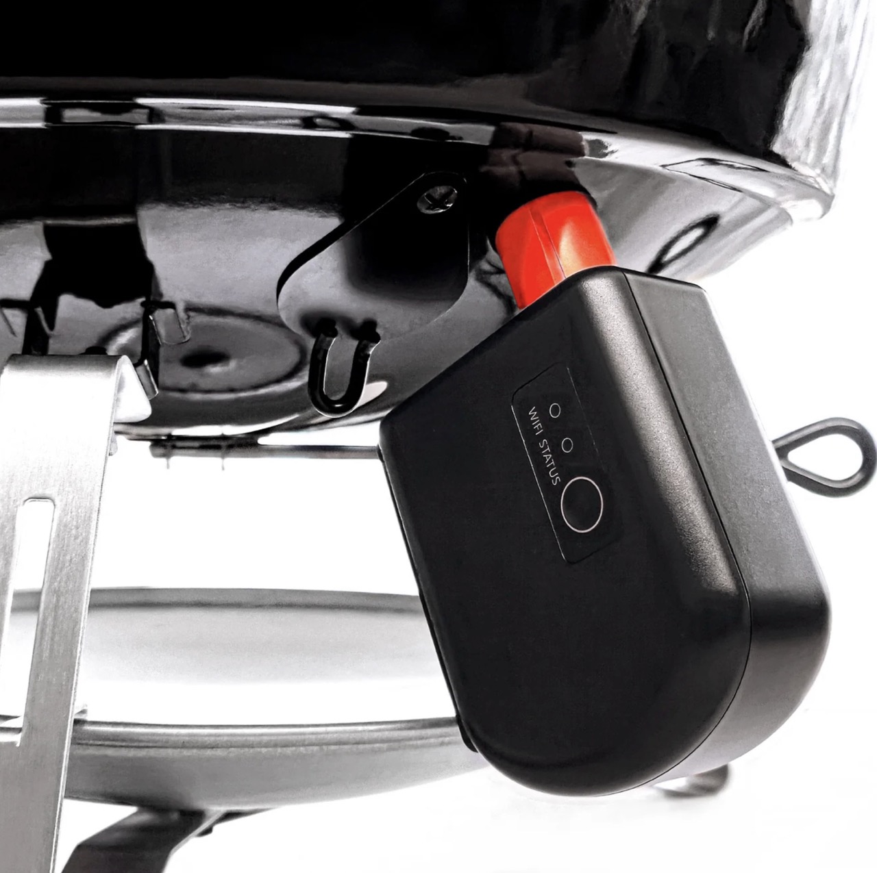 Close-up of wireless temperature monitoring accessory mounted beneath SnS charcoal kettle grill