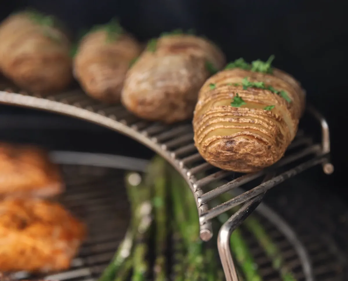 Weber Master-Touch 26" Charcoal Grill, hasselback potatoes on the warming rack above asparagus