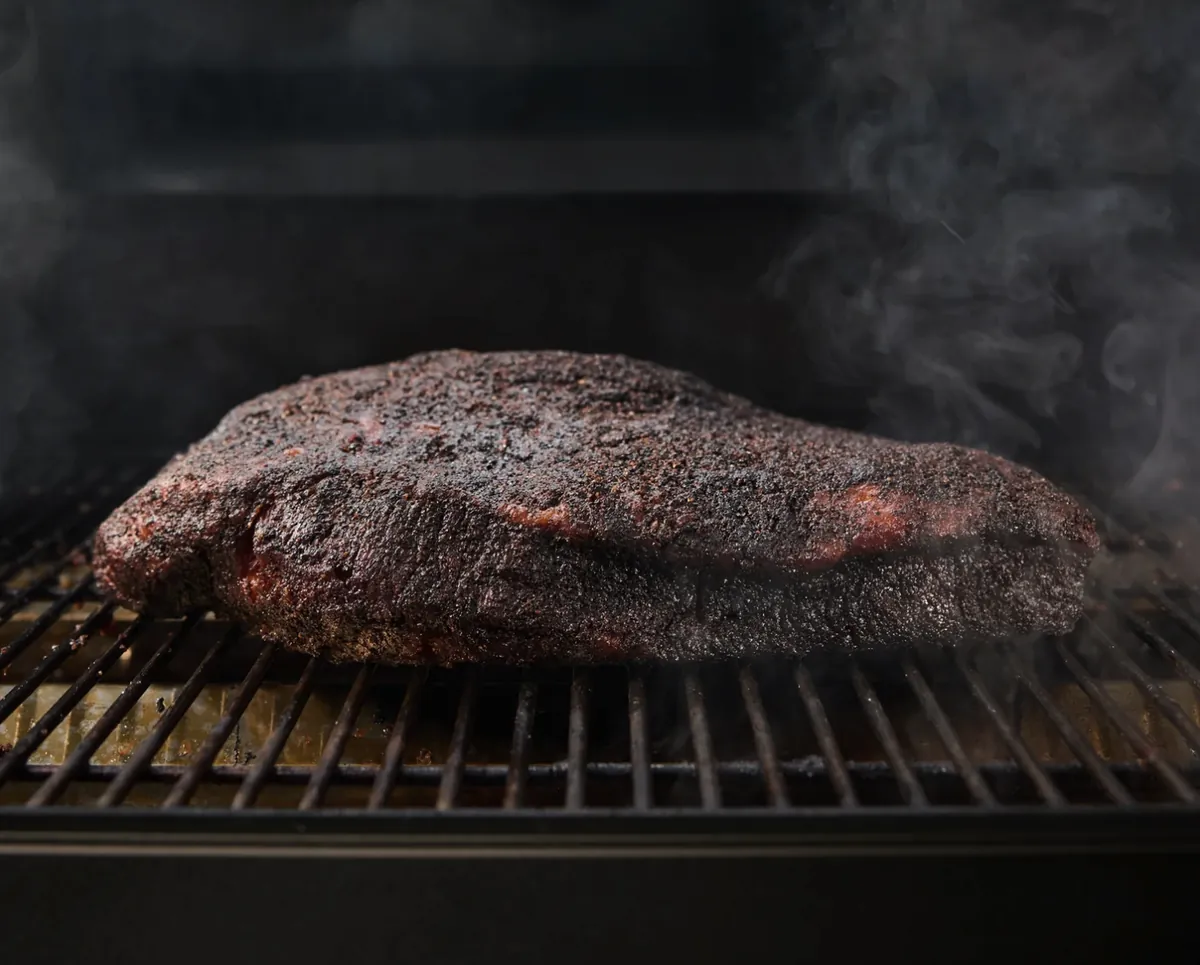 Weber Smoque Pellet Smoker, smoked brisket with dark bark on the grate