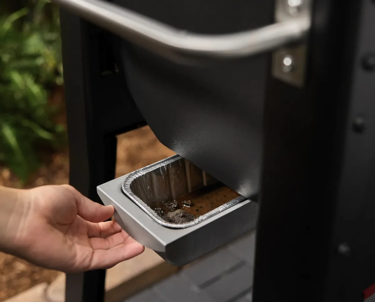 Weber Smoque Pellet Smoker, pulling out the grease tray with disposable liner